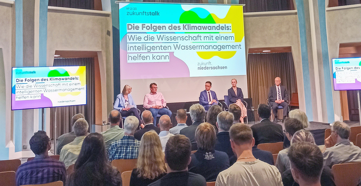 Blick auf das Podium mit Minister Falko Mohrs beim 2. Zukunftstalk in der Aula Academica der TU Clausthal.