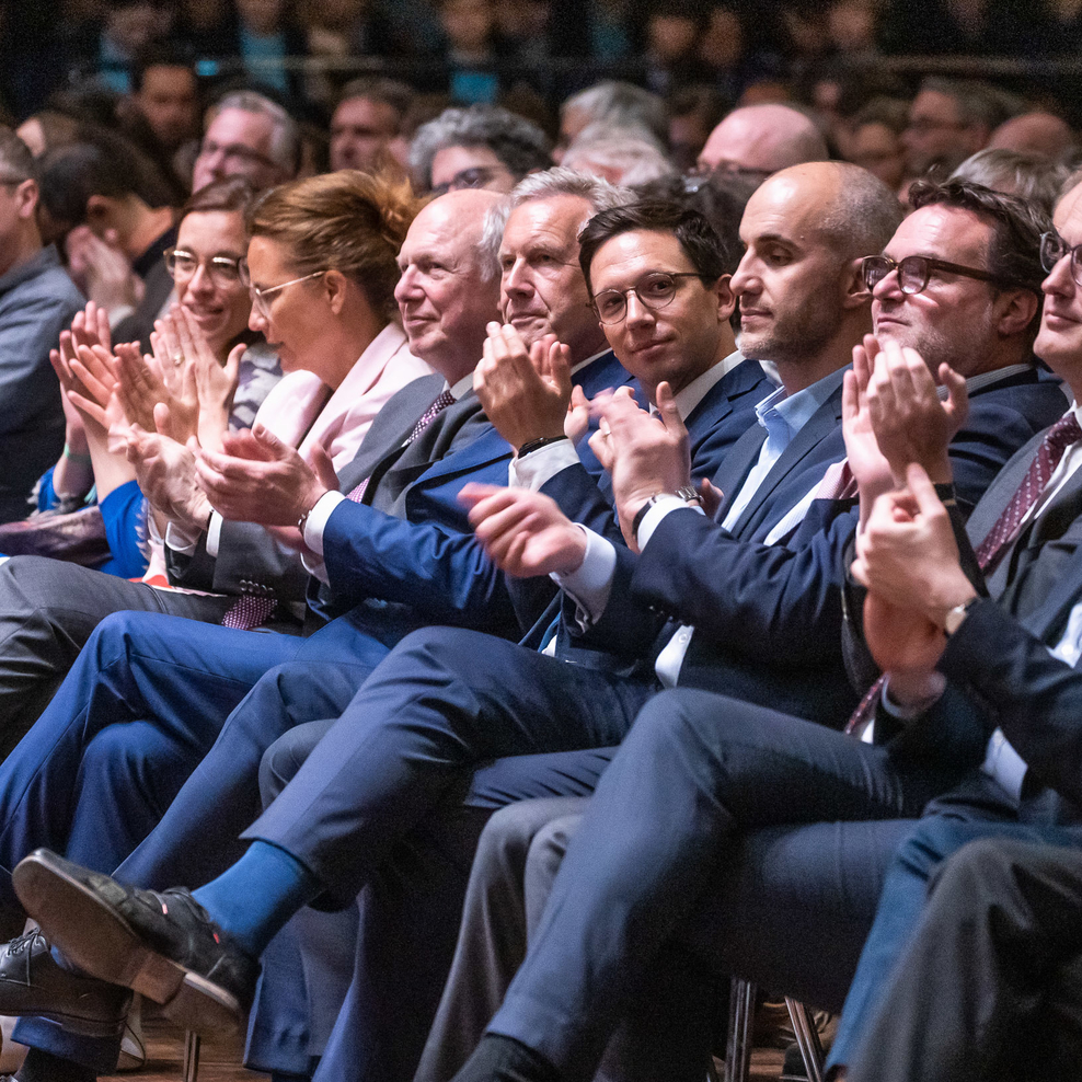 Schmuckbild: Minister Falko Mohrs sitzt in der ersten Reihe eines Publikums, alle klatschen.